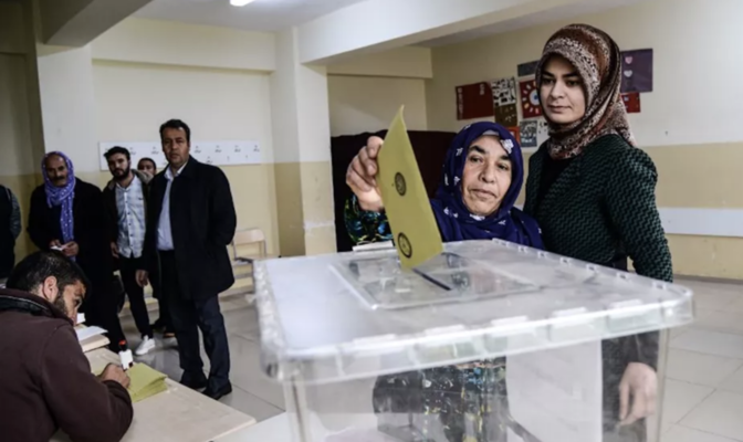 A woman casts her vote at a polling station in the southeastern Turkey Kurdish s