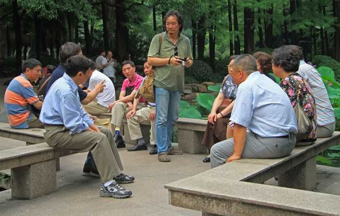 SHANGHAI, CHINA - JULY 1, 2015: chinese people are communicating in park of Shanghai, China