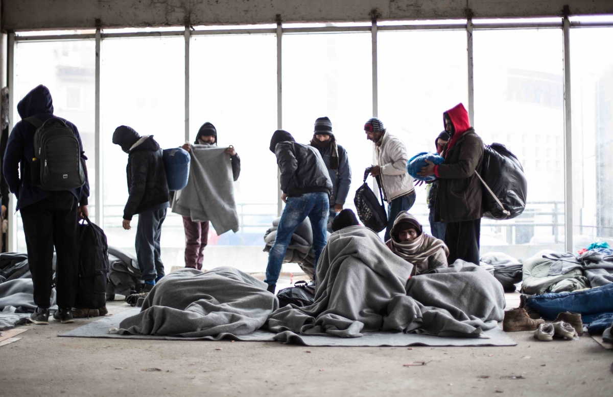 Balkan route. Men sleeping in an empty building