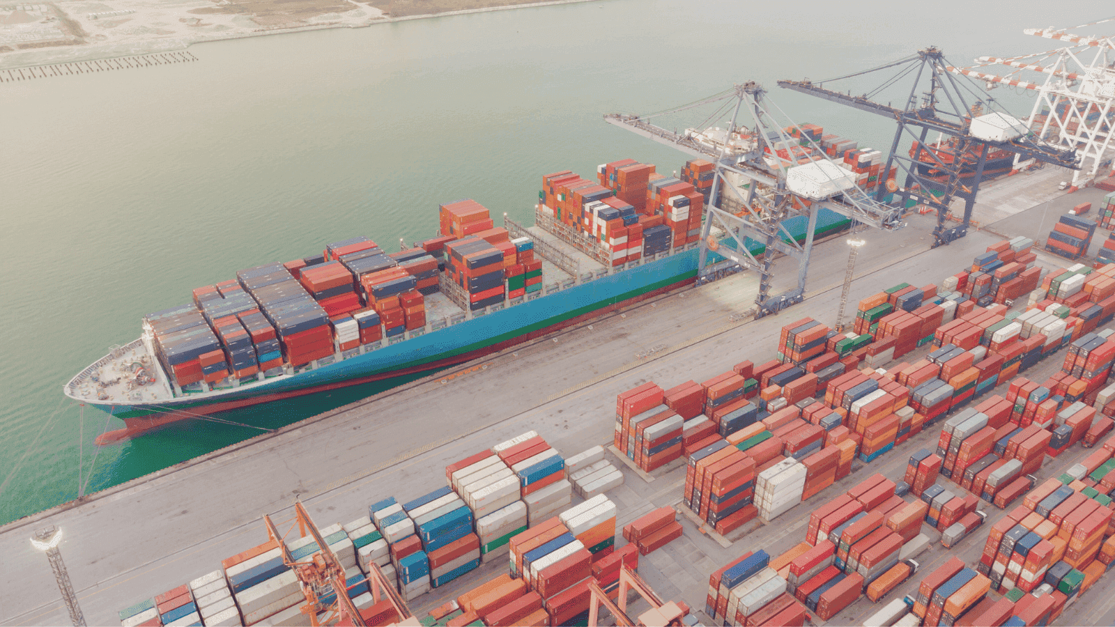 Container ship loading at a port.