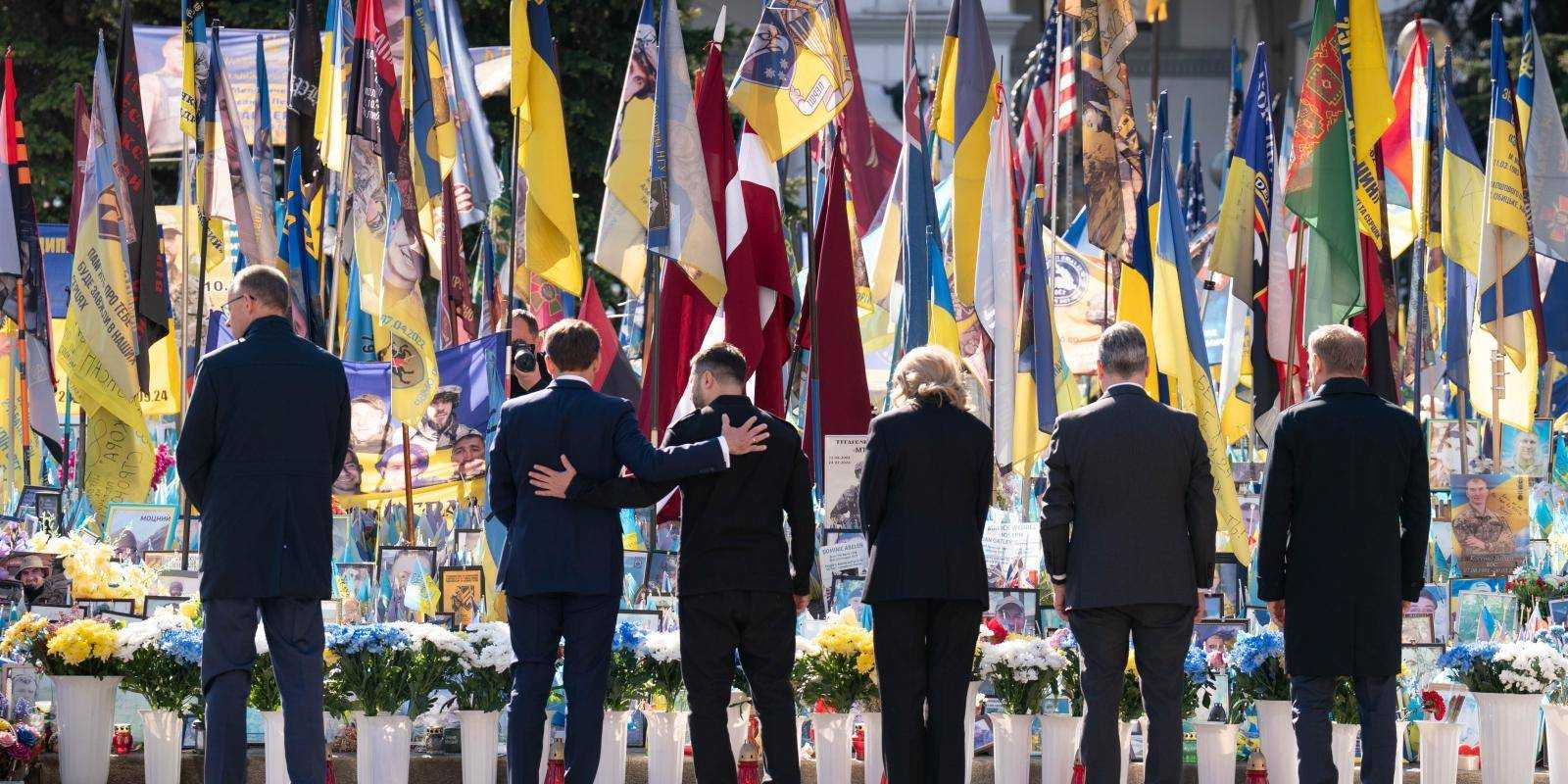 6 people in costume looking at flags