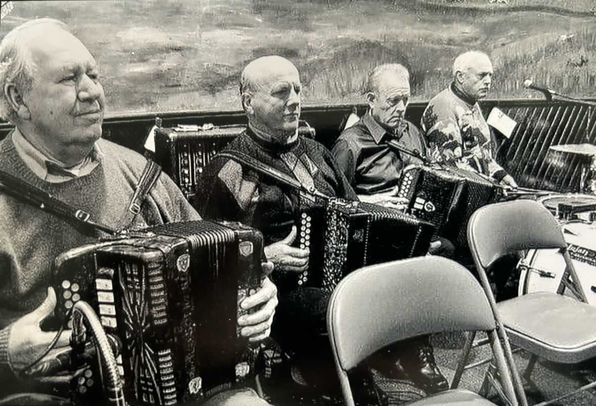 Group of elderly men playing the accordion