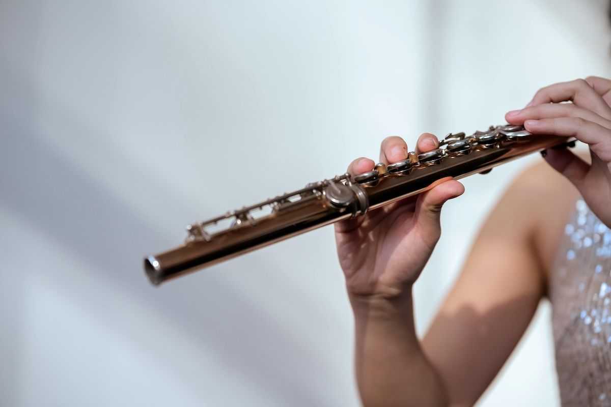 A person plays the transverse flute