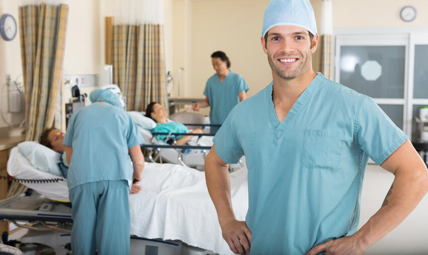 Image Tyler Olson (via Shutterstock) - Portrait of confident male nurse...