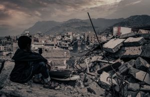 Taiz Yemen - 22 Aug 2016 : A child from Taiz City sits on the ruins of his ruined home because of the war on city-Yemen.