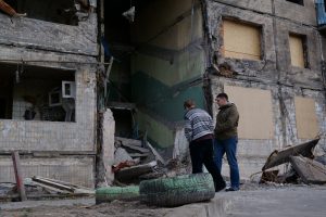 KYIV, UKRAINE, APRIL 15, 2022: After bombing. Russian aggression. War in Ukraine. People near dwelling house destroyed by russian shell on March 14, 2022