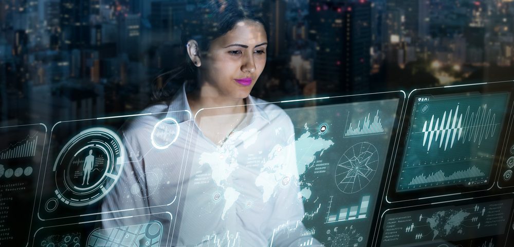 businesswoman looking at futuristic interface screen by Chombosan , Shutterstock